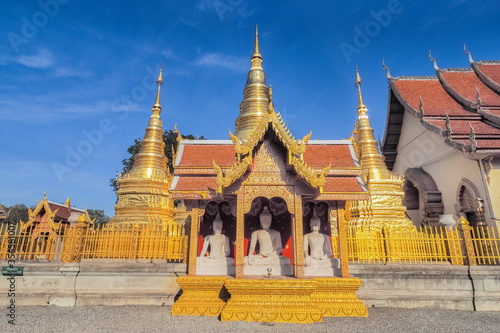 view of Golden Pagoda (Stupa, Chedi) with buddhist temple lanna style art and blue sky background, Wat Phra That Ha Duang, Li District, Lamphun, northern of Thailand. © Yuttana Joe