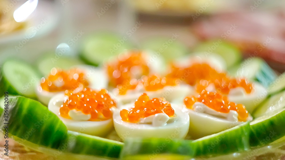 Eggs stuffed with caviar blurred background. festive kitchen to the table Eggs stuffed with caviar blurred background. festive kitchen to the table