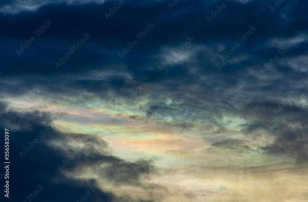 The beauty of the rainbow clouds Above the black clouds in the evening.
