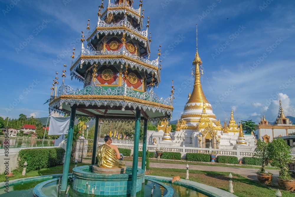 view of Golden Pagoda with blue sky background, Wat Chong Kham, Mae Hong Son, northern of Thailand.