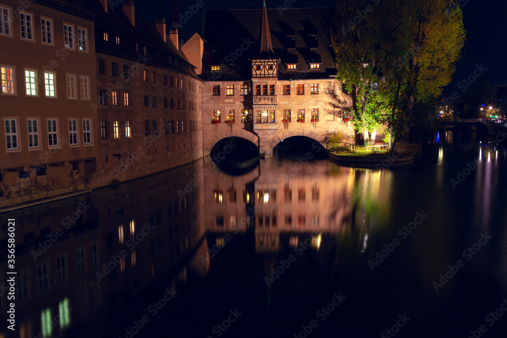 Illumination of Heilig Geist Spital in Nuremberg , Night view of Pegnitz river in Bavaria 