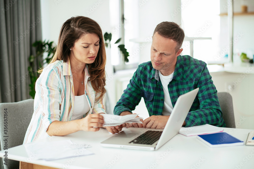 Husband and wife preparing bills to pay. Young couple having financial problems. Husband and wife preparing bills to pay. Young couple having financial problems.