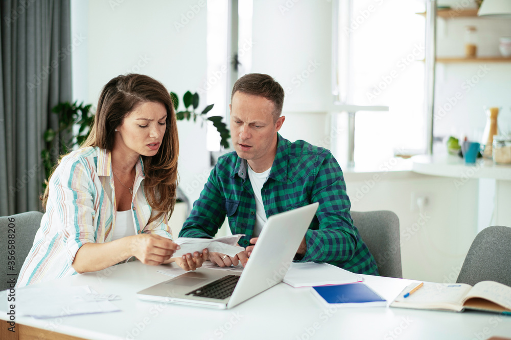 Husband and wife preparing bills to pay. Young couple having financial problems. Husband and wife preparing bills to pay. Young couple having financial problems.