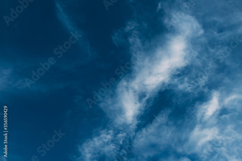 Beautiful blue sky with clouds. Sky clouds background. Fluffy white cloud formation in a beautiful blue sky. Bird's-eye view. Nice wallpaper. Summer day.