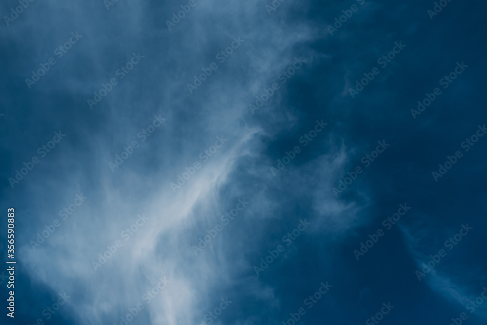 Obraz premium Beautiful blue sky with clouds. Sky clouds background. Fluffy white cloud formation in a beautiful blue sky. Bird's-eye view. Nice wallpaper. Summer day.
