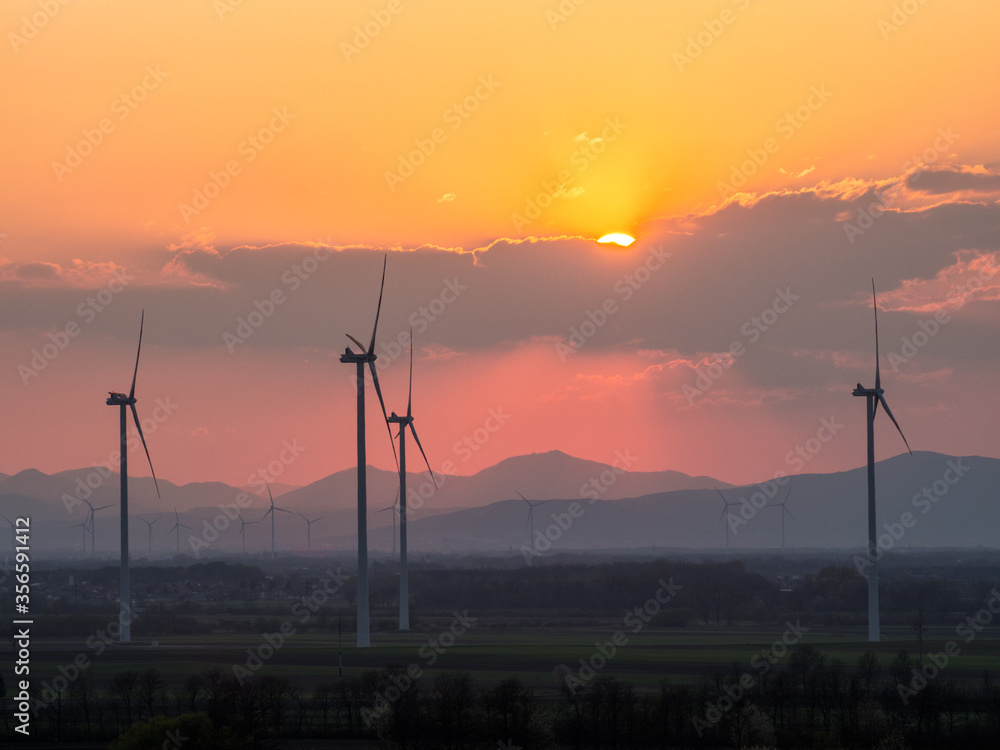 Obraz premium Windmill turbine for power generator at sunset