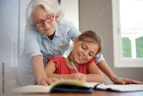 grandmother helping grandkid with homework