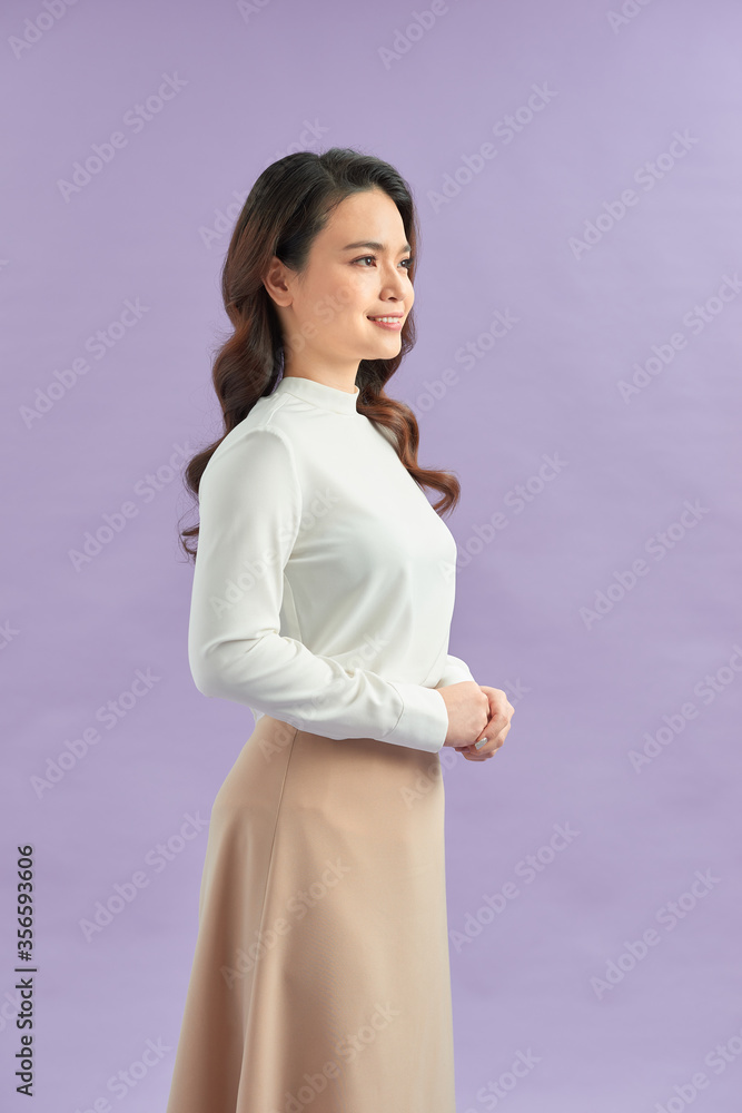 Smiling millennial woman in casual clothes isolated on purple background Smiling millennial woman in casual clothes isolated on purple background