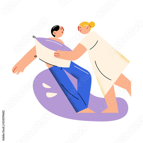 Young parents woman and man fighting with pillow and having fun