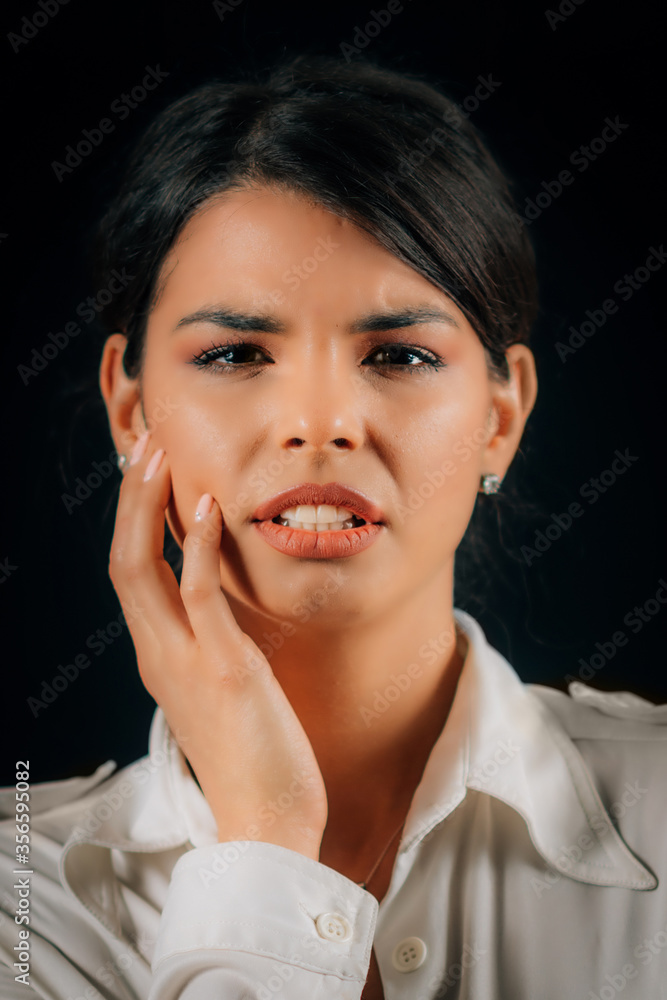 Emotion Pain. Face of a beautiful young woman feeling pain, studio portrait, black background Emotion Pain. Face of a beautiful young woman feeling pain, studio portrait, black background