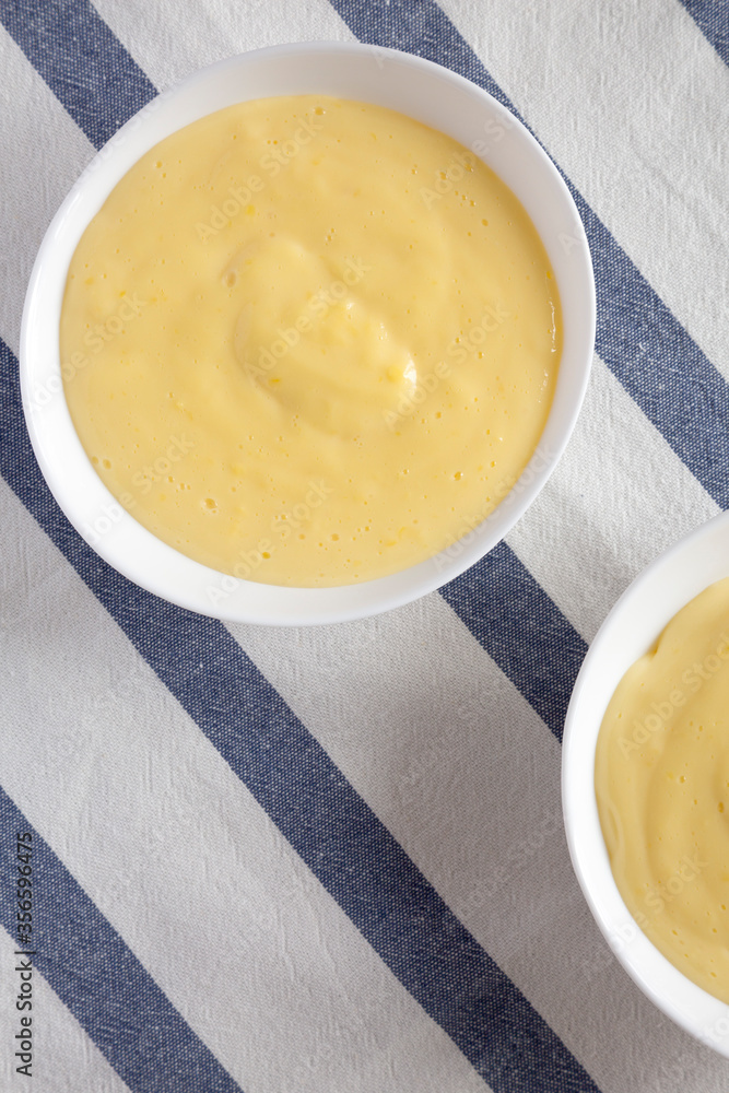 Homemade vanilla custard pudding on cloth, view from above. Overhead, flat lay, top view. Homemade vanilla custard pudding on cloth, view from above. Overhead, flat lay, top view.