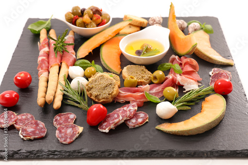 mediterranean appetizer, buffet food with salami, cantaloup, ham, olive