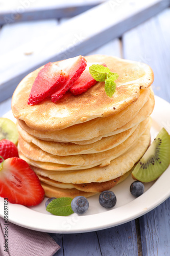 stack of pancakes with fresh fruits