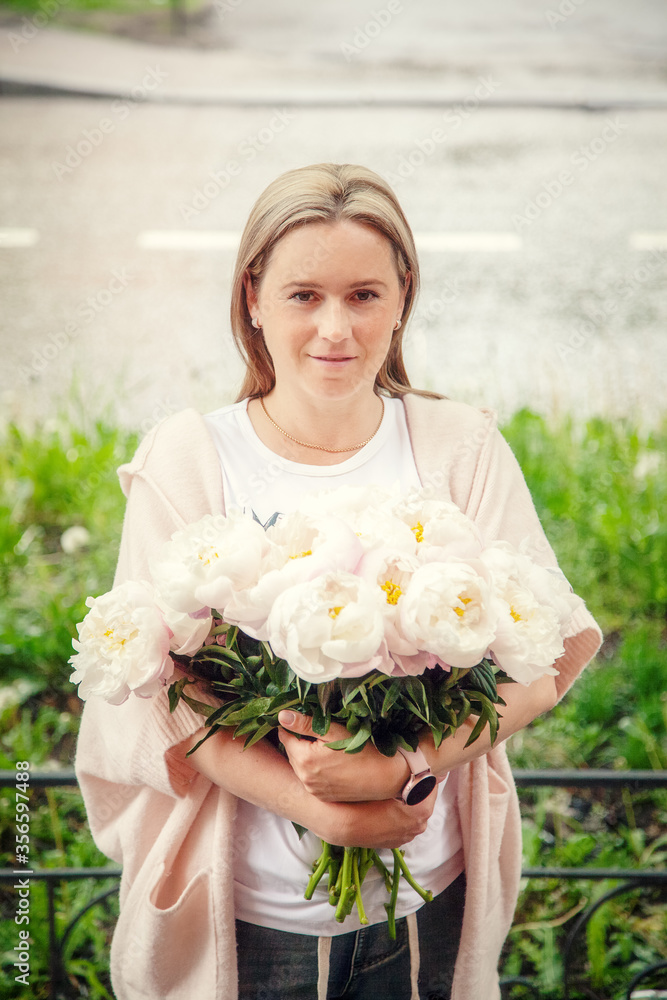 Portrait of a woman with peonies on the street Portrait of a woman with peonies on the street
