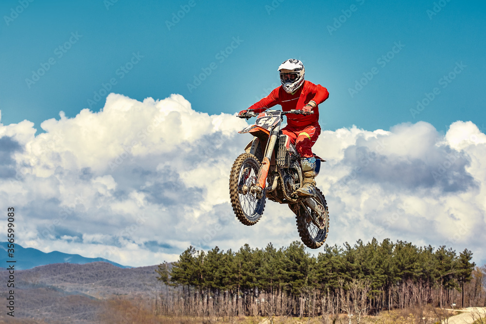Motocross concept, a biker goes off-road making extreme skiing. In pursuit of adrinalin, sport concept. Dangerous sport. Motocross concept, a biker goes off-road making extreme skiing. In pursuit of adrinalin, sport concept. Dangerous sport.