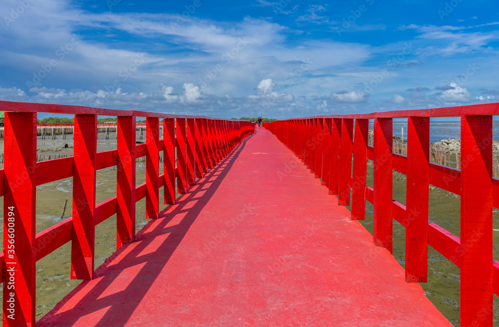 The red bridge and cloudy blue sky background. bridge cross the sea, Samutsakhon province,Thailand.