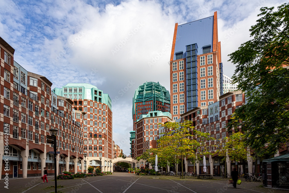 Fototapeta premium Street view of The Hague city center with the brick made skyscrapers imitating the traditional Dutch Flemish architecture, The Hague, Netherlands