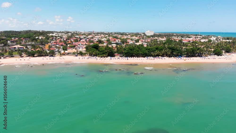 Drone flying from right to left showing the shore of Itapuã beach, Salvador Bahia, Brazil.