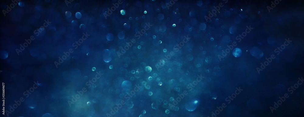 background of abstract glitter lights. balck and blue. de focused
