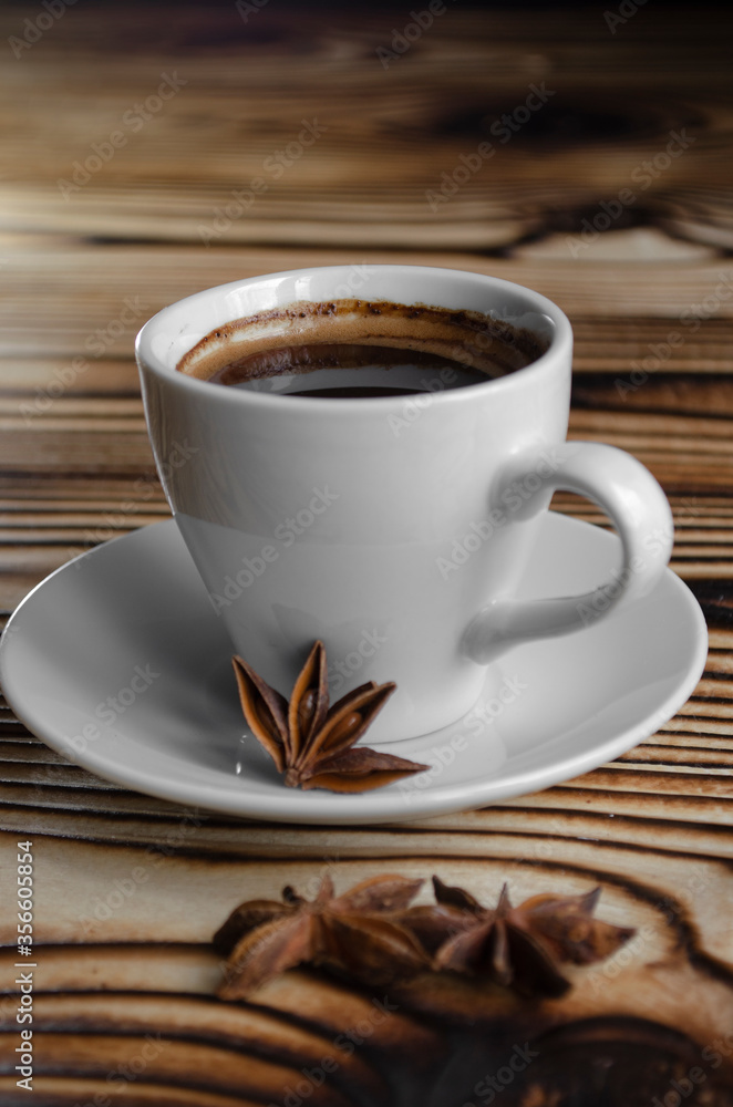 espresso on wooden background with star anise and cinnamon espresso on wooden background with star anise and cinnamon