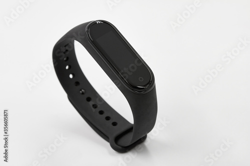 Black fitness watch or activity tracker on white background.