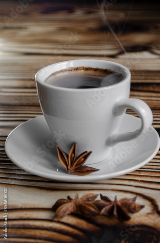 espresso on wooden background with star anise and cinnamon