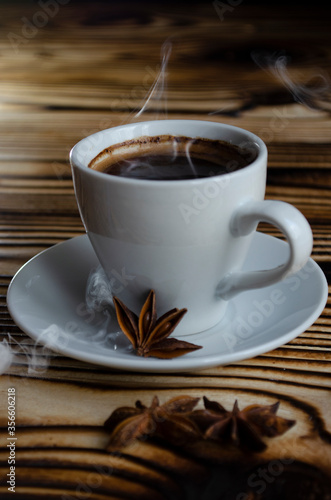 espresso on wooden background with star anise and cinnamon