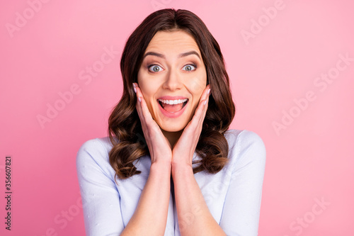 Closeup photo of stunning attractive pretty lady wavy hairdo beaming smiling good mood listen amazing news arms on cheeks wear casual white pullover isolated pink color background