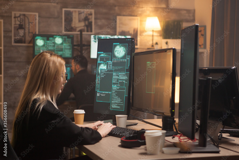 Nonconformist female hacker making a malicious malware with her team