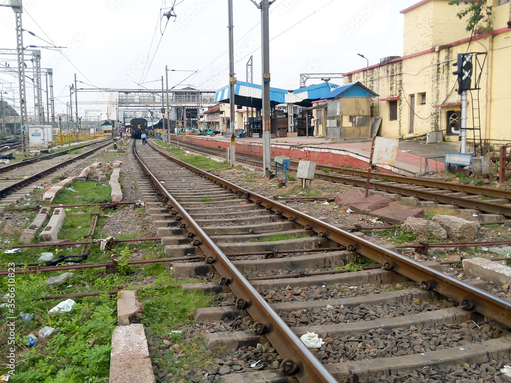 Close Up of Indian Railway Tracks low angel view from a rails sleepers near railway station platform during day time in Howrah Station car shed area. Kolkata India South Asia Pacific March 18, 2020 Close Up of Indian Railway Tracks low angel view from a rails sleepers near railway station platform during day time in Howrah Station car shed area. Kolkata India South Asia Pacific March 18, 2020