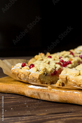 sliced ​​homemade grated pie with berries