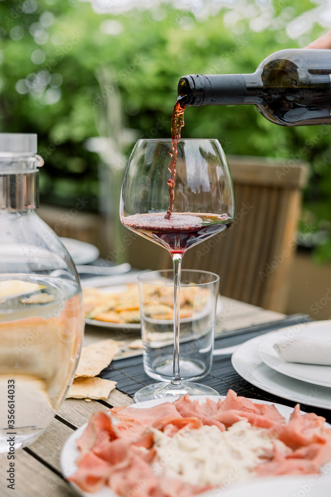 Pour red wine. red wine on the dining table Pour red wine. red wine on the dining table