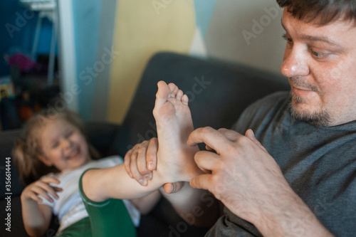 Obraz na plátne dad plays at home with his children: daughters, son