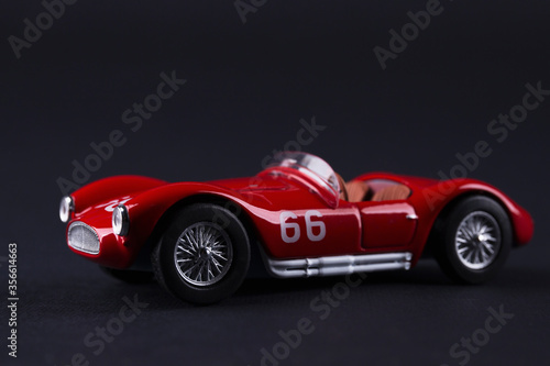 Classic red sport car model scale on black background