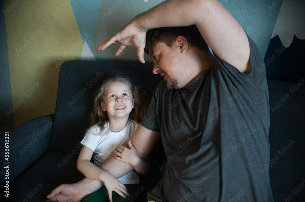 Obraz premium dad plays at home with his children: daughters, son