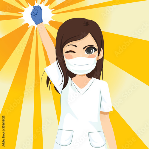 Beautiful young female nurse winking and raising fist up power concept