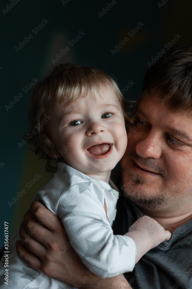 Portrait Of Dad With Son At Home. Dad with one year old son at home Portrait Of Dad With Son At Home. Dad with one year old son at home