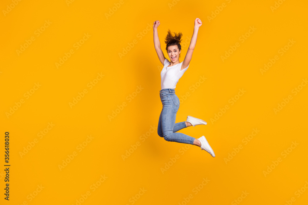 Full length body size view of her she nice attractive pretty sporty fit slim thin cheerful cheery girl jumping having fun rejoicing isolated on bright vivid shine vibrant yellow color background