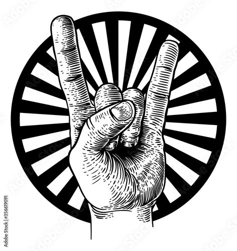 A hand doing a heavy metal rock music sign gesture in a vintage woodcut retro style