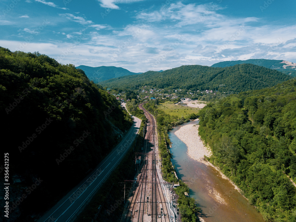 Aerial view of highway and railway between the greenmountains Aerial view of highway and railway between the greenmountains