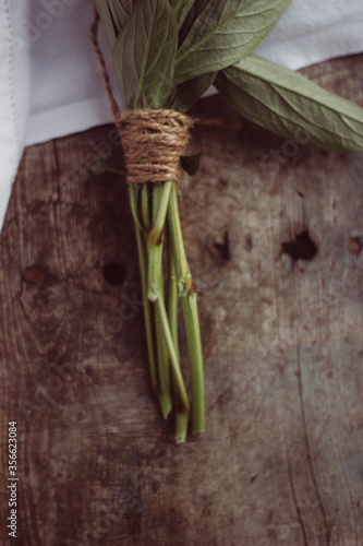 tied flowers with a cord lying on a wooden background