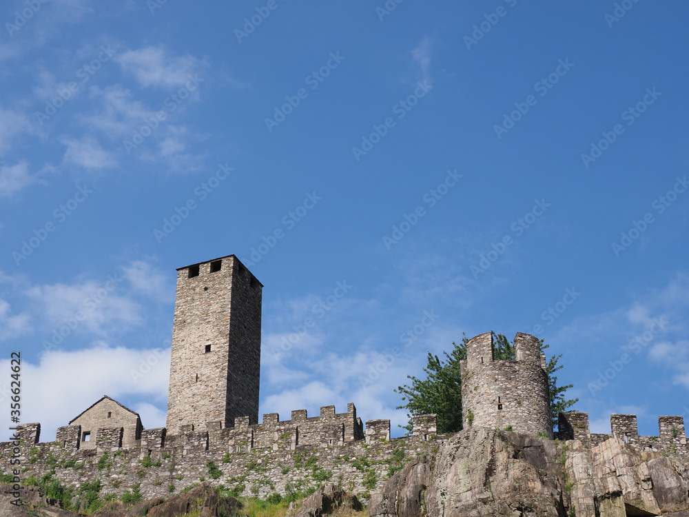 Towers of castel grande in european Bellinzona city, capital of canton Ticino in Switzerland, clear blue sky in 2017 warm sunny summer day on July.