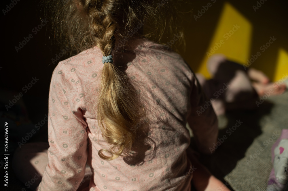 little girl pigtail in the sun at home little girl pigtail in the sun at home