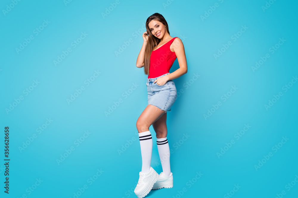 Full length photo of charming pretty nice girl look enjoy spring free time weekend want attract guy touch hand hairstyle wear tank-top shoes isolated over blue color background Full length photo of charming pretty nice girl look enjoy spring free time weekend want attract guy touch hand hairstyle wear tank-top shoes isolated over blue color background