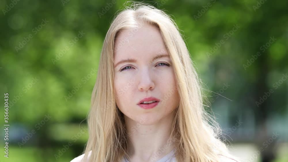 Portrait of a cute young blonde girl with hair flowing in the light wind on the natural background of the park on a sunny summer day
Portrait of a cute young blonde girl with hair flowing in the light wind on the natural background of the park on a sunny summer day