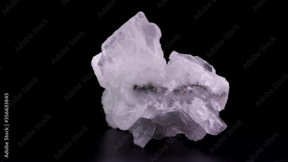 Apophyllite crystals slowly rotating over a black background Apophyllite crystals slowly rotating over a black background