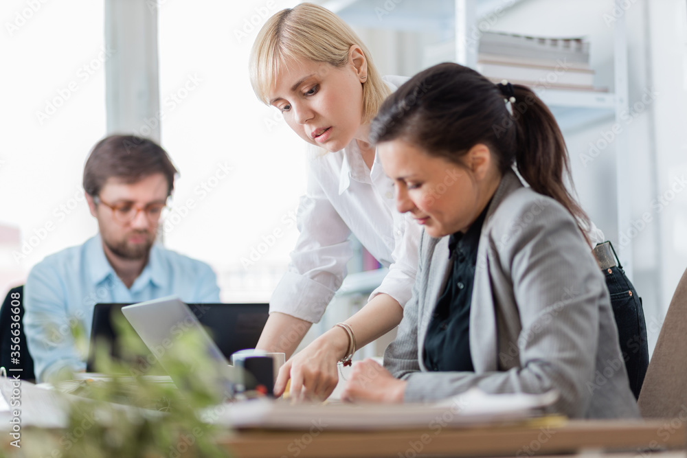© Suteren Studio - Colleagues working at office