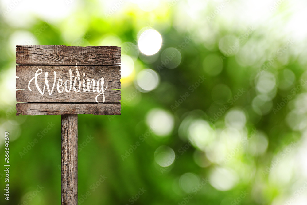Wooden plaque with inscription Wedding outdoors, space for text