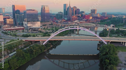 Aerial: Traffic over the Korean Veterans Memorial Bridge & downtown Nashville at sunrise. Tennessee, USA photo
