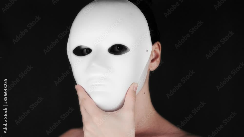 The girl takes off the theater mask and looks at the camera. The girl in theatrical makeup. Halloween concept. 4k footage The girl takes off the theater mask and looks at the camera. The girl in theatrical makeup. Halloween concept. 4k footage